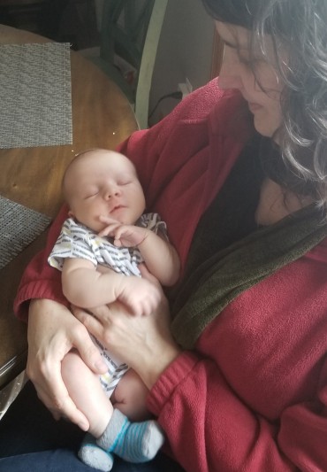 holding a newborn infant